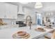 Modern kitchen with white cabinets and a large island at 17574 W Cardinal Dr, Goodyear, AZ 85338