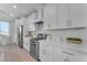 Modern kitchen with white cabinets and stainless steel appliances at 17574 W Cardinal Dr, Goodyear, AZ 85338