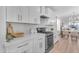 Modern kitchen with white cabinets, gas range, and quartz countertops at 17574 W Cardinal Dr, Goodyear, AZ 85338