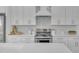 Modern kitchen with white cabinets, stainless steel appliances, and white backsplash at 17574 W Cardinal Dr, Goodyear, AZ 85338