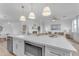 Kitchen island with white quartz countertop and built-in microwave at 17574 W Cardinal Dr, Goodyear, AZ 85338