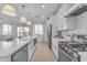 Open concept kitchen with white cabinets and a large island at 17574 W Cardinal Dr, Goodyear, AZ 85338
