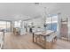 Modern kitchen with white cabinets, island, and dining area at 17574 W Cardinal Dr, Goodyear, AZ 85338