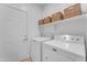 Laundry room with washer, dryer, and additional storage shelves at 17574 W Cardinal Dr, Goodyear, AZ 85338