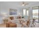 Bright living room features a comfy sofa, stylish armchairs, and a neutral color palette at 17574 W Cardinal Dr, Goodyear, AZ 85338