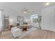 Spacious living area with sectional sofa, large window and hardwood floors at 17574 W Cardinal Dr, Goodyear, AZ 85338
