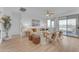 Open living room with hardwood floors, neutral decor, and access to backyard at 17574 W Cardinal Dr, Goodyear, AZ 85338