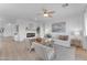 Spacious living room with fireplace, hardwood floors, and plenty of natural light at 17574 W Cardinal Dr, Goodyear, AZ 85338