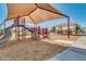 Shaded playground with slides and climbing structures at 17574 W Cardinal Dr, Goodyear, AZ 85338