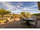 Outdoor dining area with seating, fire pit and built-in grill at 17848 E Stocking Trl, Rio Verde, AZ 85263