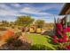 Landscaped backyard with seating area and lush greenery at 17848 E Stocking Trl, Rio Verde, AZ 85263