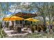 Outdoor seating area with umbrellas and a bar at the community clubhouse at 17848 E Stocking Trl, Rio Verde, AZ 85263