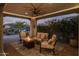 Covered patio with fire pit and comfortable seating area at 17848 E Stocking Trl, Rio Verde, AZ 85263