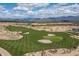 Aerial view of a lush golf course with mountains in the background at 17848 E Stocking Trl, Rio Verde, AZ 85263