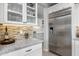 Bright kitchen with white cabinetry, granite countertops, and a large stainless steel refrigerator at 17848 E Stocking Trl, Rio Verde, AZ 85263