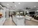 Open concept kitchen with island, white cabinets, and living room view at 17848 E Stocking Trl, Rio Verde, AZ 85263