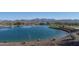 Serene lake with mountain backdrop and walking path at 17848 E Stocking Trl, Rio Verde, AZ 85263