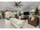 Spacious living room with white sofa, large TV and access to backyard at 17848 E Stocking Trl, Rio Verde, AZ 85263