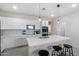 Modern kitchen with white cabinets, quartz countertops, and stainless steel appliances at 17923 W Louise Dr, Surprise, AZ 85387