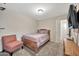 Bedroom with double bed, armchair, and TV at 18963 N Vemto St, Maricopa, AZ 85138