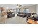 Spacious living room featuring a sectional sofa and access to the kitchen at 18963 N Vemto St, Maricopa, AZ 85138
