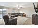 Living room with sectional sofa and ceiling fan at 18963 N Vemto St, Maricopa, AZ 85138