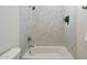 Bathroom with bathtub shower and marble tile surround at 19910 N 84Th St, Scottsdale, AZ 85255