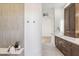 Bright bathroom with wood cabinetry, double sink, and tiled floors at 19910 N 84Th St, Scottsdale, AZ 85255