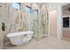 Spa-like bathroom with a freestanding tub and a large walk-in shower at 19910 N 84Th St, Scottsdale, AZ 85255