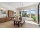 Bright dining room with a large window, wooden table, and views of the backyard at 19910 N 84Th St, Scottsdale, AZ 85255