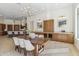 Spacious dining room featuring a wooden table with seating for six and built-in cabinets with a wine cooler at 19910 N 84Th St, Scottsdale, AZ 85255