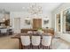 Elegant dining room featuring a wooden table, upholstered chairs, and stylish lighting at 19910 N 84Th St, Scottsdale, AZ 85255