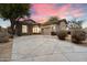 Single-story home with stone accents and a two-car garage at 19910 N 84Th St, Scottsdale, AZ 85255