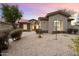 Single-story home exterior at dusk with stone accents and desert landscaping at 19910 N 84Th St, Scottsdale, AZ 85255