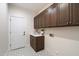 Laundry room with custom cabinetry and tile flooring at 19910 N 84Th St, Scottsdale, AZ 85255