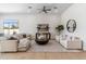Comfortable living room featuring neutral furniture, a large round coffee table, and bright natural light at 19910 N 84Th St, Scottsdale, AZ 85255
