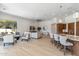 Open-concept living room with light hardwood floors, neutral furniture, and large windows offering outdoor views at 19910 N 84Th St, Scottsdale, AZ 85255