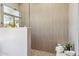 Modern walk-in shower with neutral-toned tile and glass surround at 19910 N 84Th St, Scottsdale, AZ 85255