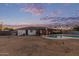 Spacious backyard with a pool, covered patio, and ample space for outdoor activities at 2037 E Riviera Dr, Tempe, AZ 85282
