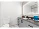 Clean bathroom with gray vanity, granite countertop, and toilet at 2037 E Riviera Dr, Tempe, AZ 85282