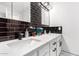 Bathroom with double sinks, dark tile, and white vanity at 2037 E Riviera Dr, Tempe, AZ 85282
