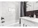 Modern bathroom with white and black tile, bathtub, and updated vanity at 2037 E Riviera Dr, Tempe, AZ 85282