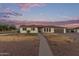 A single-story home with a well-manicured lawn and beautiful landscaping at 2037 E Riviera Dr, Tempe, AZ 85282