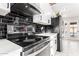 Modern kitchen with black tile backsplash and stainless steel appliances at 2037 E Riviera Dr, Tempe, AZ 85282