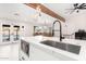 Modern kitchen island with marble countertop and black faucet at 2037 E Riviera Dr, Tempe, AZ 85282