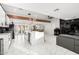 Modern kitchen with white cabinets, marble countertops, and stainless steel appliances at 2037 E Riviera Dr, Tempe, AZ 85282