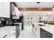 Modern kitchen with white cabinets, marble countertops, and stainless steel appliances at 2037 E Riviera Dr, Tempe, AZ 85282
