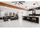 Open living room and kitchen with tile floors and modern light fixtures at 2037 E Riviera Dr, Tempe, AZ 85282