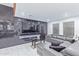 Stylish living room features a marble accent wall and a comfortable sectional sofa at 2037 E Riviera Dr, Tempe, AZ 85282