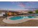 Backyard pool with a basketball hoop, surrounded by a fence and mature landscaping at 2037 E Riviera Dr, Tempe, AZ 85282